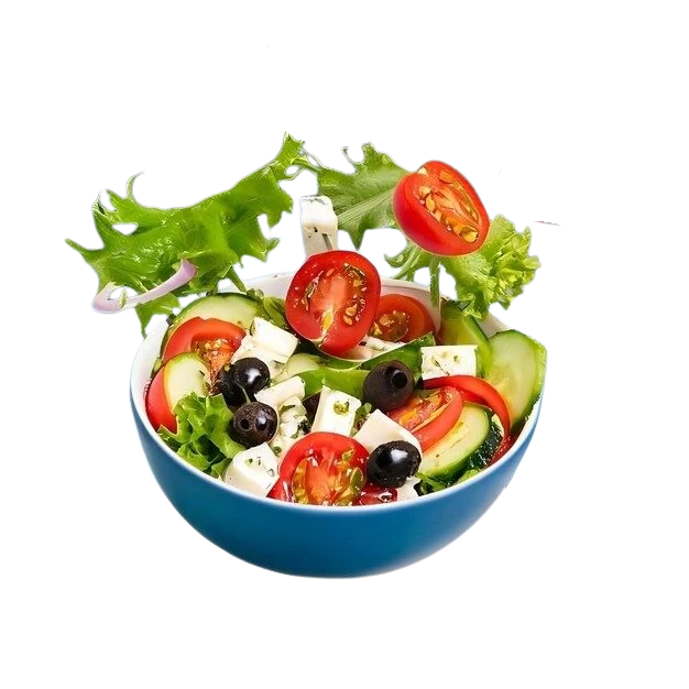 Fresh salad tossed above a blue bowl at SLYCE Pizza Cafe